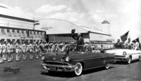 3. President Eisenhower upon arrival greeting the troops.  The hangar in the background today is hangar # 1 where the Wings Over The Rockies Air & Space Museum is located.  [Wings Museum]