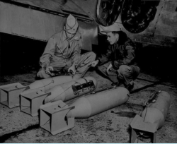 Inspecting Flash Bombs prior to a night-time photo mission.  (Wings)