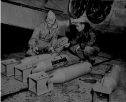 Inspecting Flash Bombs prior to a night-time photo mission.  (Wings)