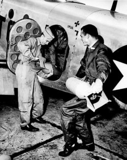 Photo School students loading Flash Bombs aboard photo recon aircraft, enabled night-time photography.  (Wings)